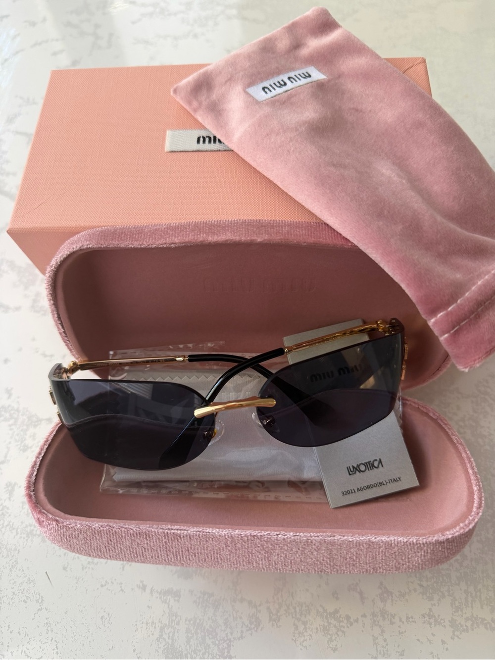 Miu Miu Black Lens Sunglasses with Gold Frame